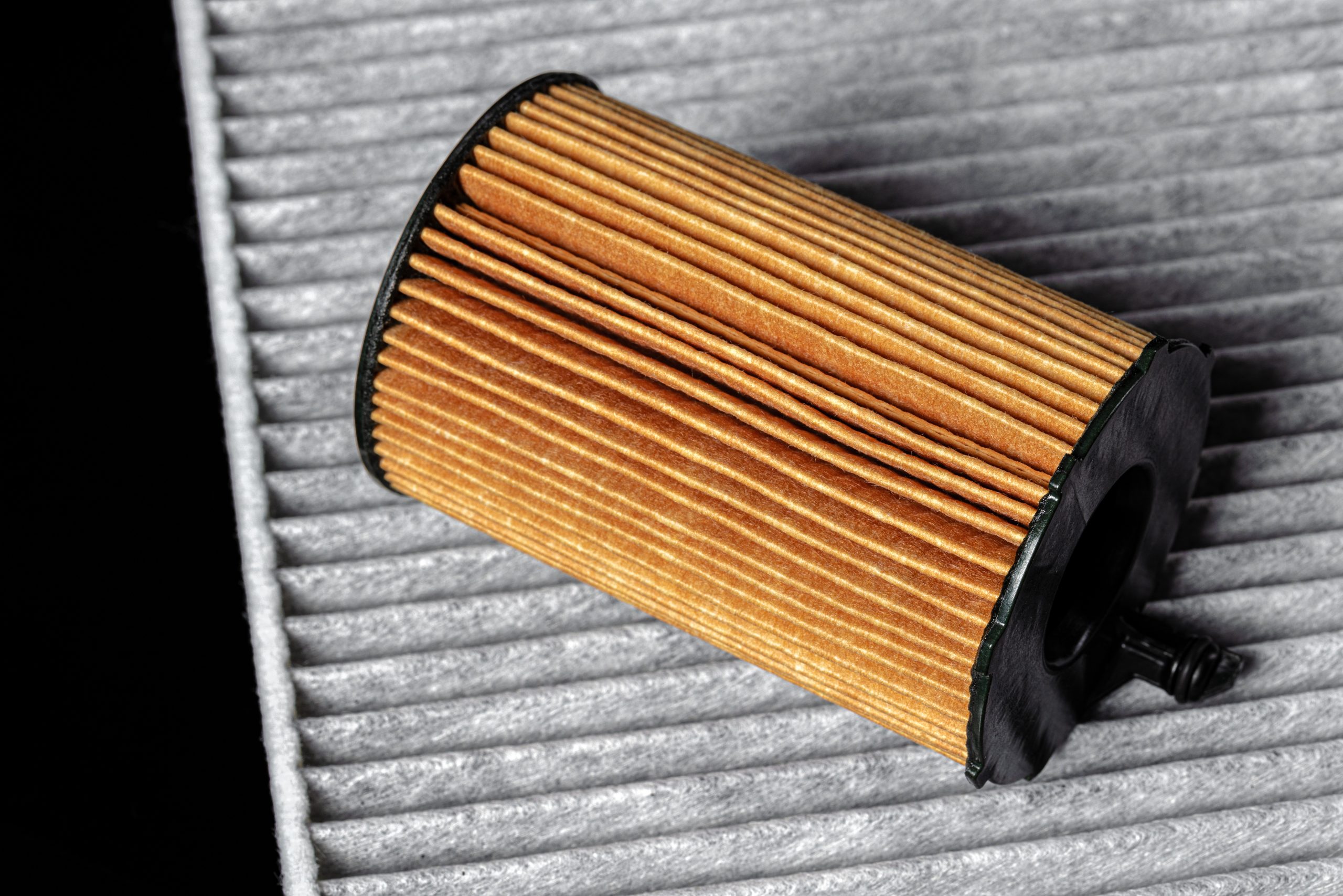 Car engine filter on dark background, close up.